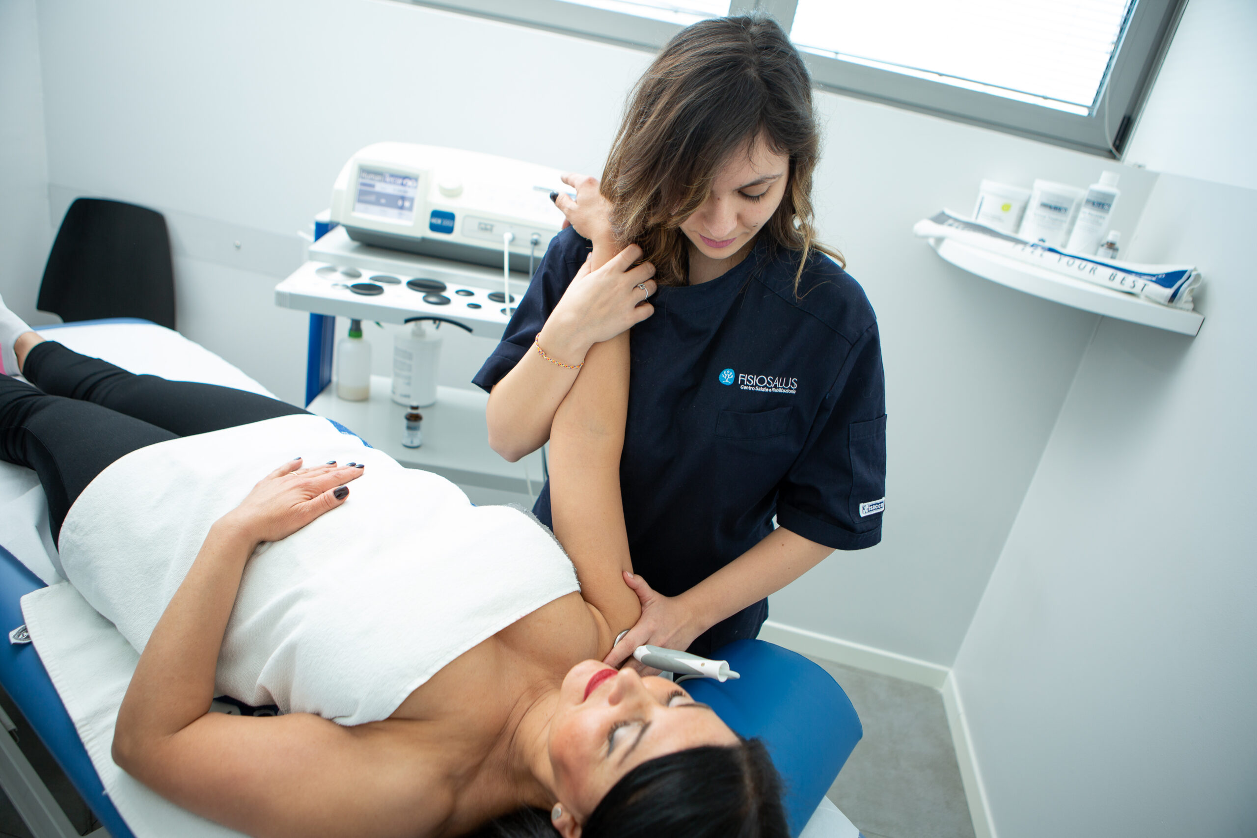 Terapista fisioterapista in azione presso FisioSalus: trattamento riabilitativo personalizzato per il recupero completo del paziente